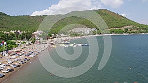 View from above of Turkey beach with many colourful umbrellas. Vacation in beautiful Marmaris Turkey.