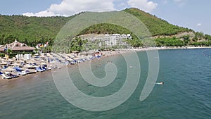 View from above of Turkey beach with many colourful umbrellas. Vacation in beautiful Marmaris Turkey.