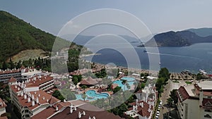 View from above of Turkey hotel resort and beach with many colourful umbrellas. Vacation in Marmaris Turkey.