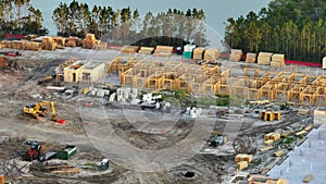 View from above of unfinished frame of apartment condo with wooden roof beams under construction. Development of