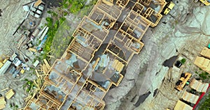 View from above of unfinished frame of apartment condo with wooden roof beams under construction. Development of