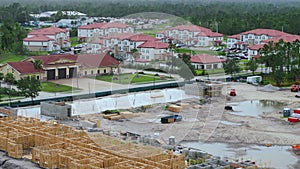 View from above of unfinished frame of apartment condo with wooden roof beams under construction. Development of