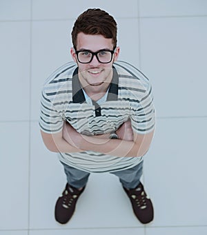 View from above of a young smiling man wearing glasses