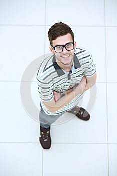 View from above of a young smiling man wearing glasses