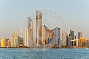 View of Abu Dhabi financial district skyline at golden hour. Luxury lifestyle hotels and business of United Arab Emirates.