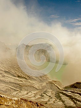 View on the acidic crater lake of the Ijen volcano in Indonesia, a sulfur mine and toxic gaz