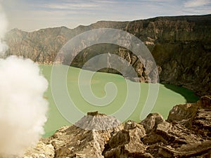 View on the acidic crater lake of the Ijen volcano in Indonesia, a sulfur mine and toxic gaz