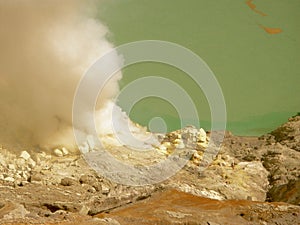 View on the acidic crater lake of the Ijen volcano in Indonesia, a sulfur mine and toxic gaz