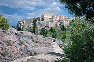 View of Acropolis hill from Areopagus hill on summer day with great clouds in blue sky, Athens, Greece. UNESCO world