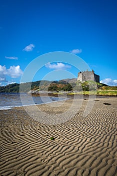 View Across the Beach Towards Castle Tiorum on a Sunny Day at Lo