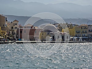 A view across Chania harbour, Crete with the backdrop of the White Mountains in the distant haze