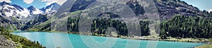 view across clear turquoise water of lake