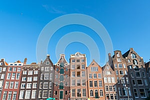 View across Damrak bay to Old Quarter and it`s iconic canal houses with their typically Dutch gables