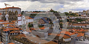 View across Douro river of Dom Luis I bridge and Vila Nova de Gaia with terracotta roofs of the Ribeira, Porto, Portugal photo