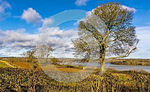 A view across the fields and hedgerows towards Pitsford Reservoir, UK