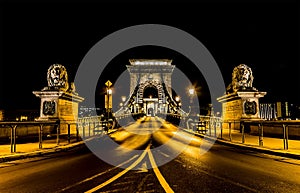 A view across the illuminated Chain Bridge across the River Danube in Budapest at night