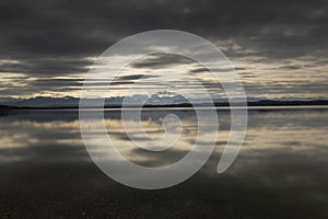 View across lake Starnberger See, Germany, to the alps on a winter day