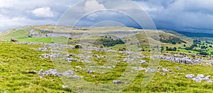 A view across limestone pavement and the southern slopes of Ingleborough, Yorkshire, UK