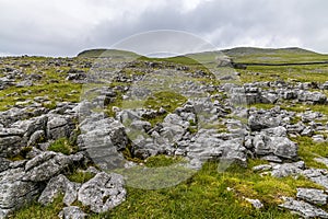 A view across limestone pavement towards glacial erratics on the southern slopes of Ingleborough, Yorkshire, UK photo