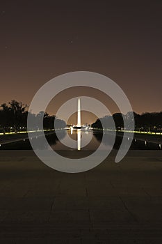 View across the Lincoln Memorial Reflecting Pool towards the washington Monument at night-time, National Mall, Washington DC