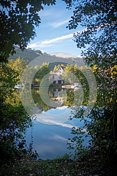 A view across the Lot River of an old house in Cajarc, Southwest France
