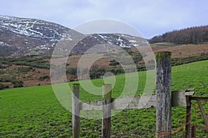 A view across one of the many snow topped hills and valleys of the Mourne Mountains in County down in Northern Ireland on a dull m