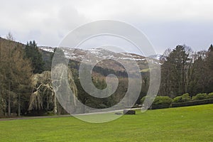 A view across one of the many snow topped hills and valleys of the Mourne Mountains in County down in Northern Ireland on a dull m