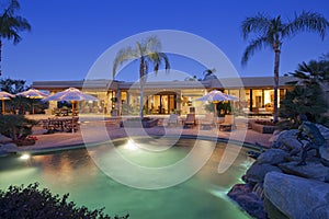 View across a pool to patio of luxury home