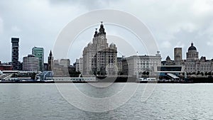 View across the river Mersey to Liverpool city skyline and the Liver building