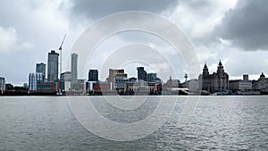 View across the river Mersey to Liverpool city skyline and the Liver building