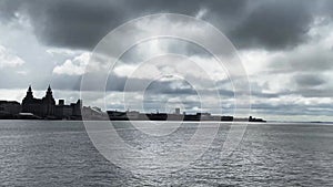 View across the river Mersey to Liverpool city skyline and the Liver building