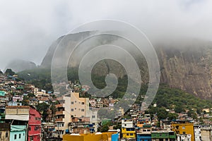 View across the Rocinha favela with rooftops and a high hillside in the background in Rio de Janeiro, Brazil, South America