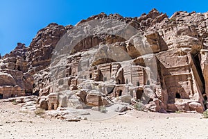 A view across a rock face with cave dwellings in the ancient city of Petra, Jordan