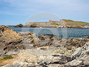 View across rocky bay to Fort Grosnez from Fort Doyle, Alderney, Channel Islands