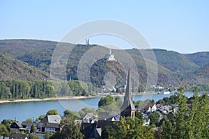 view across the roofs of Rhens to Marksburg above Braubach