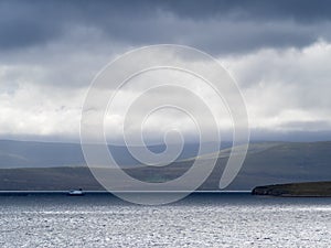View across Scapa Flow, Mainland, Orkney towards the isle of Hoy with dramatic clouds and lighting