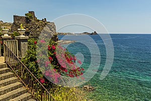 A view across the seafront in Acicastello, Sicily looking towards the Norman castle