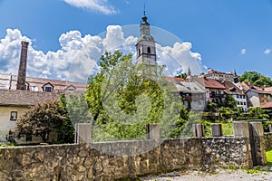 A view across the Selca Sora river towards the cathedral in the old town of Skofja Loka, Slovenia