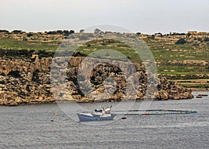 View across St Pauls Bay with yacht and fish farm, Bugibba, on Mediterranean island of Malta, Europe