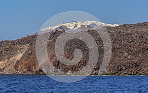 A view across the volcanic island of Nea Kameni, Santorini towards the caldera rim in the background