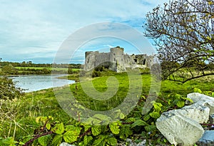 A view across a wall of the Carew River and the old castle in Pembrokeshire