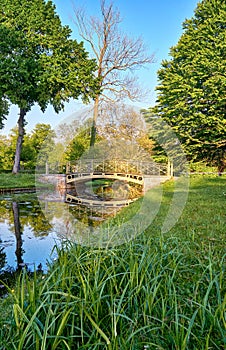 View across the water to the historic bridge in the Schwerin Palace Gardens. Water landscape