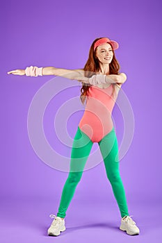 View of active red-haired fitness girl dressed in 80s style