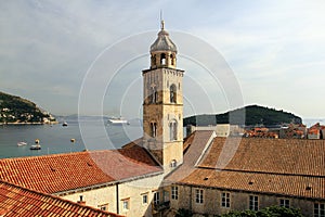 View of the Adriatic Sea over the red tiled roofs, Dominican monastery bell-tower in the forefront, Dubrovnik, Croatia