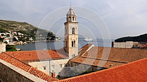 View of the Adriatic Sea over the red tiled roofs, Dominican monastery bell-tower in the forefront, Dubrovnik, Croatia