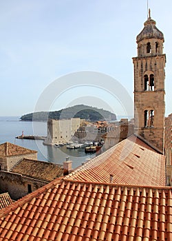 View of the Adriatic Sea over the red tiled roofs, Dominican monastery bell-tower in the forefront, Dubrovnik, Croatia