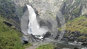 View from afar on the abundant Kurkure waterfall in the Altai Republic in Russia