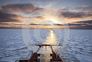 View from the aft of a research vessel crusing in ice during sun