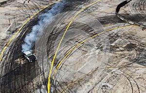 A view from the air racing drift car with a lot of smoke on the