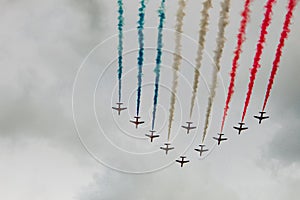 View of an air show with colorful smokes on a cloudy day background